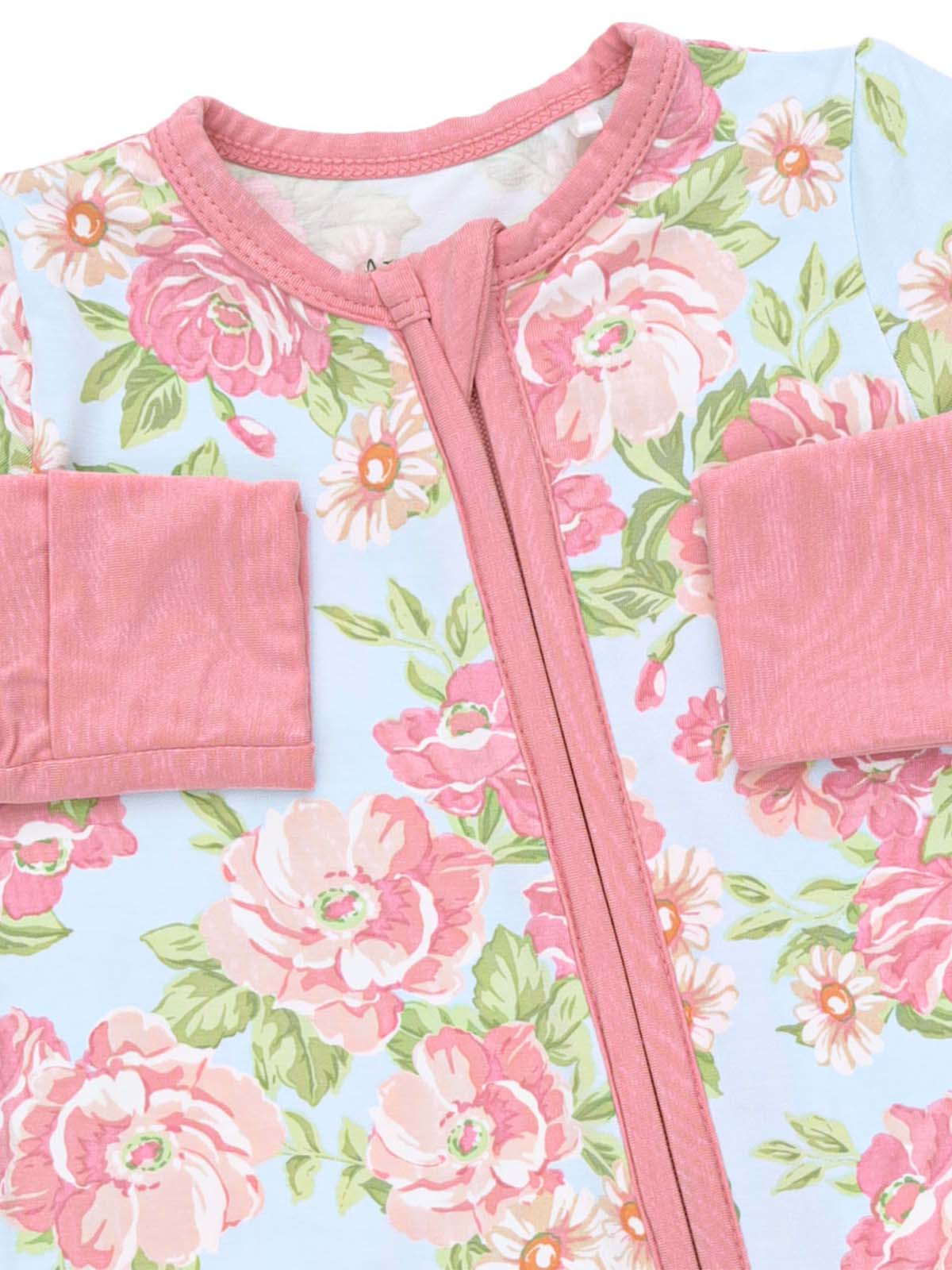 Floral-patterned children's romper in soft pastel colors with a pink zipper and sleeves.