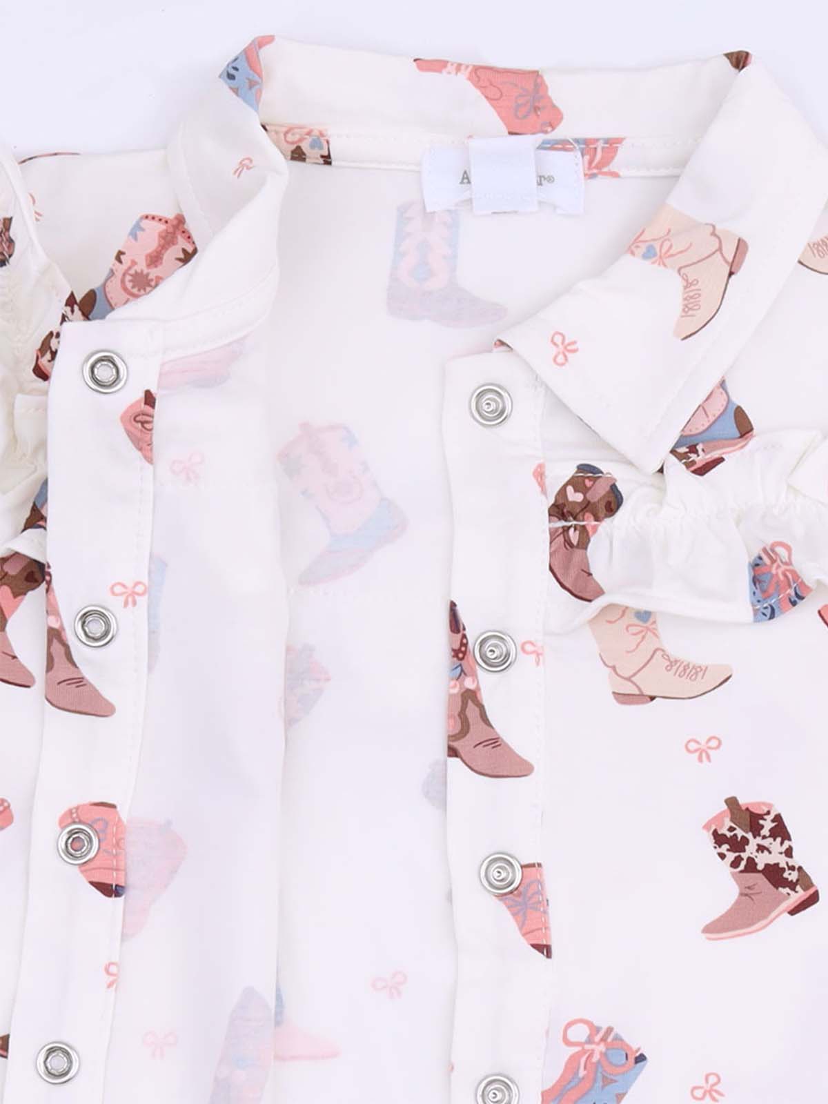 White shirt with colorful cowboy boot prints and button closures. Ideal for casual wear.