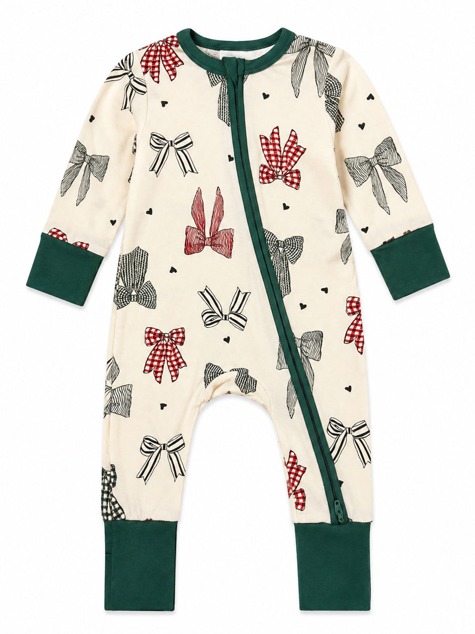 Cream-colored onesie with colorful bows and a green zipper, perfect for cozy playtime.
