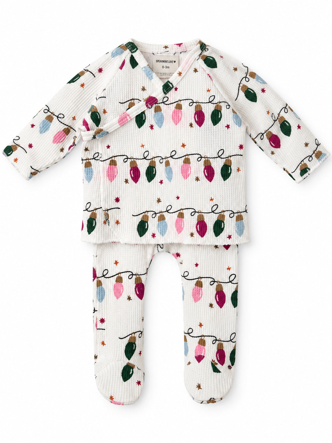 White infant outfit featuring colorful holiday lights pattern, consisting of a long-sleeve top and leggings.