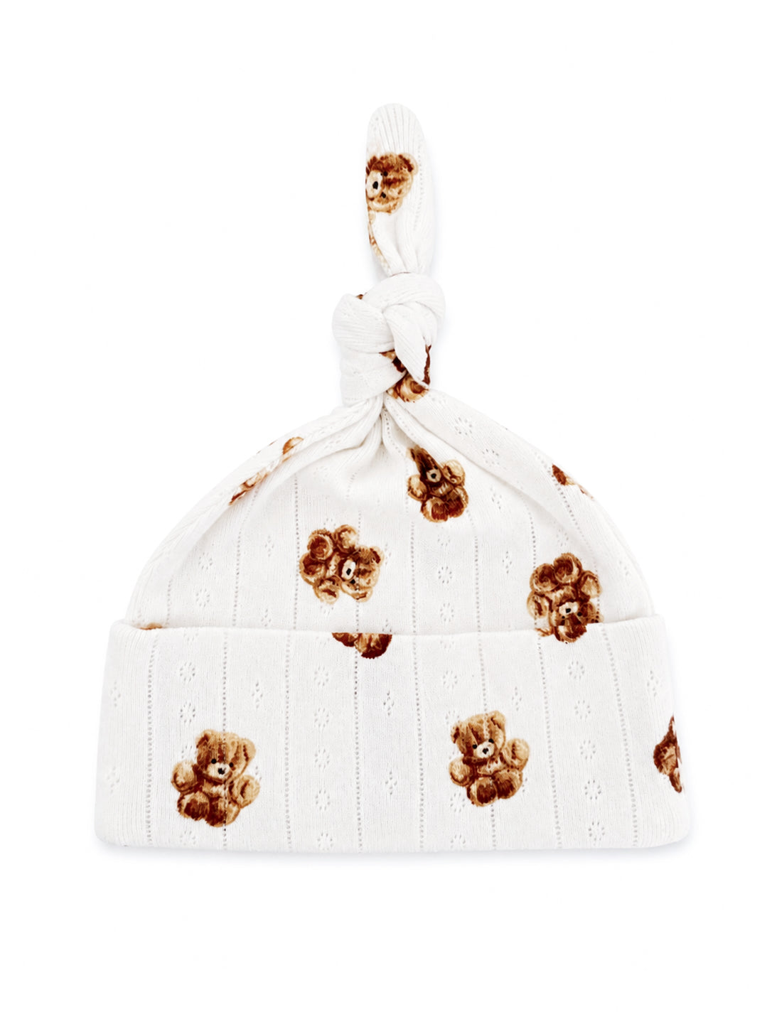 White baby hat with a knot at the top, featuring a teddy bear print and delicate, textured design.