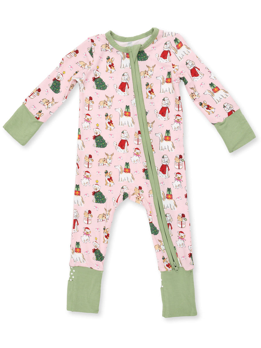 Pink children's pajamas with festive animal and holiday patterns, featuring long sleeves and a green trim.