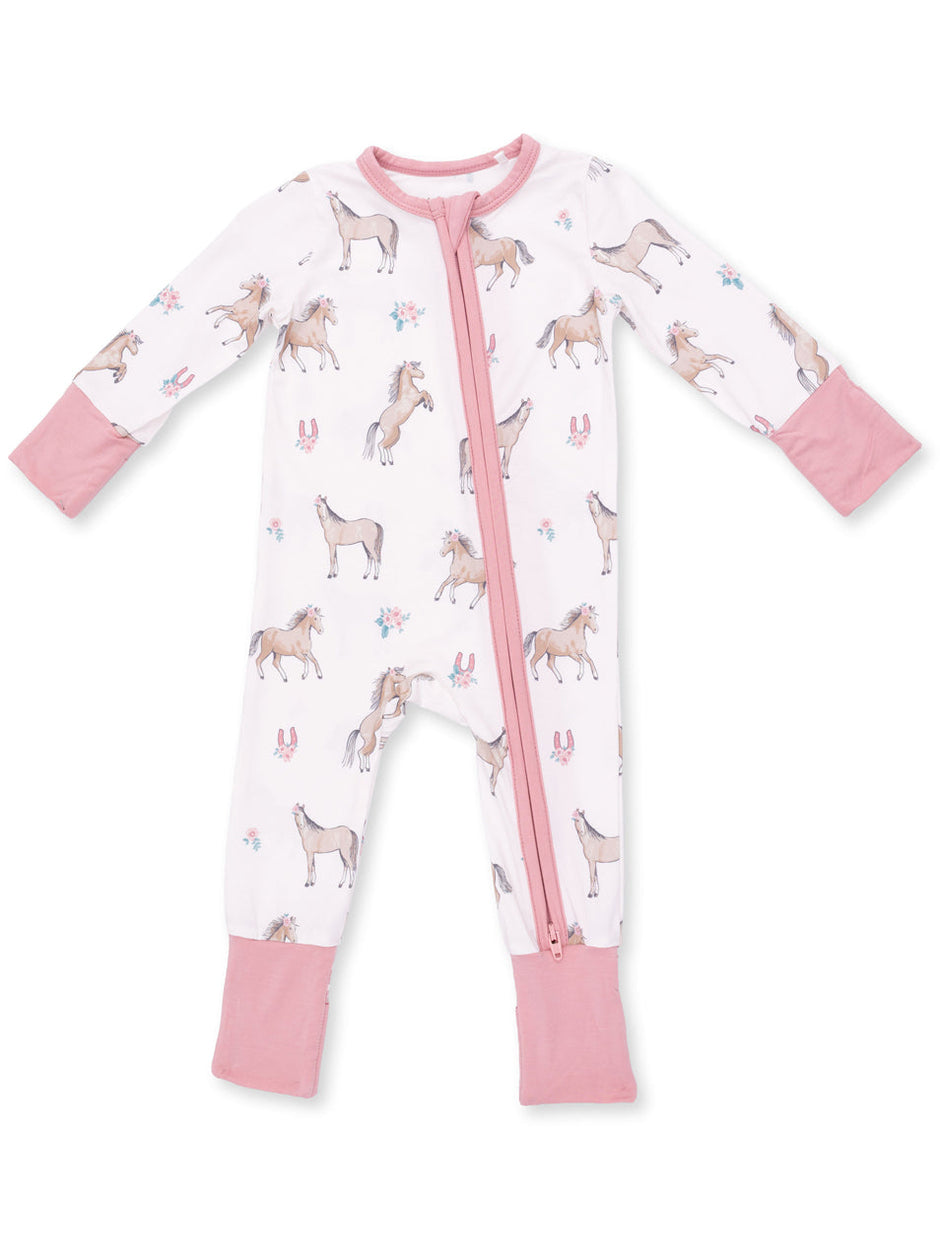 Unicorn-patterned baby pajama with pink accents and a front zipper. Ideal for comfy nighttime wear.