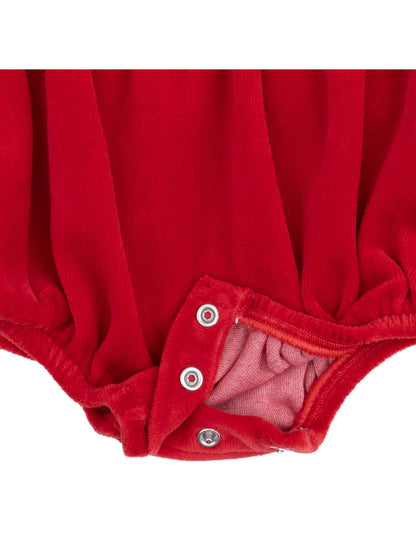 Red baby romper with snap closures at the bottom, showcasing soft fabric texture.