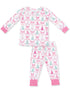 Pink and white children's pajamas featuring a holiday tree pattern with bows.