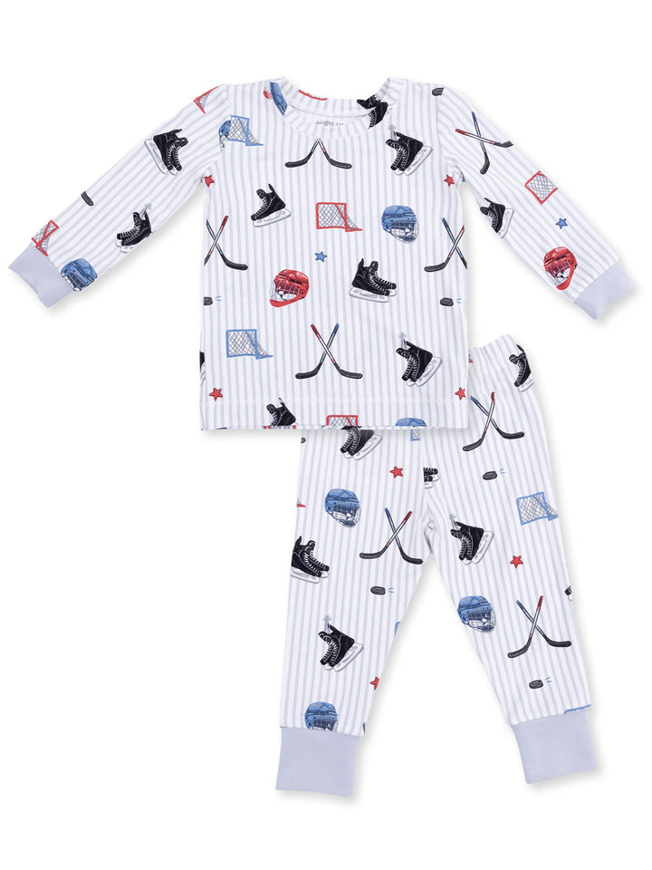 Kids' hockey-themed pajamas with hockey sticks, skates, and helmets on a striped background. Perfect for young fans.
