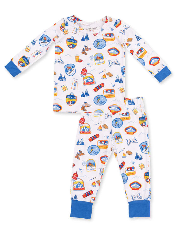 Children's pajama set featuring colorful travel-themed prints and blue accents. Perfect for cozy sleepwear.