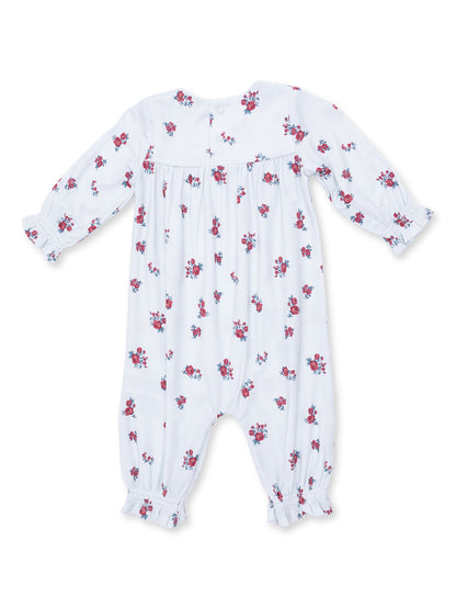 White baby romper with red and blue floral patterns and long sleeves, featuring elastic cuffs and button closure.