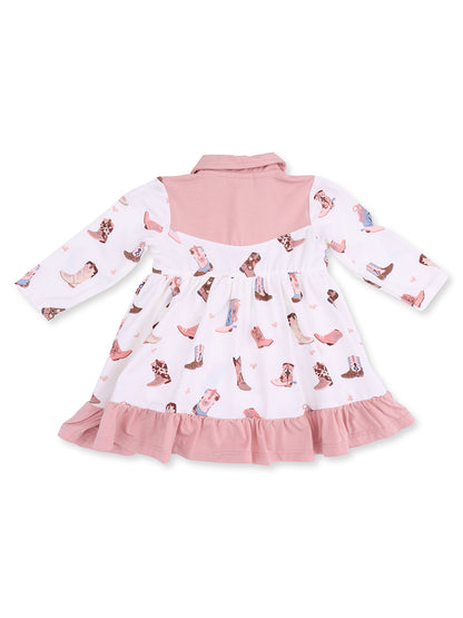 Back view of a children’s dress with a pink collar and patterned boots on a white fabric. Flared hem with ruffle details.