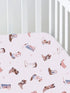 Cotton crib sheet with pink background and colorful cowboy boot patterns.