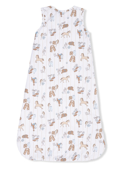Horse-themed sleep sack featuring playful illustrations of horses, saddles, and cowboy gear on a white background.