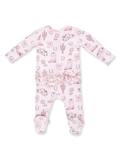 Pink baby outfit with Western prints like boots, cacti, and bows, featuring ruffled details and footed pants.