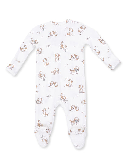 White baby onesie featuring playful puppy print and grippy feet for comfort and safety. Ideal for lounging or sleep.