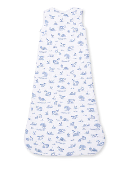 White sleep sack with blue farm animal and nature print, featuring horses, cows, trees, and birds.