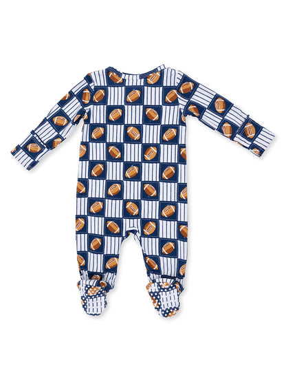 Blue and white baby onesie featuring a football pattern on a grid background.