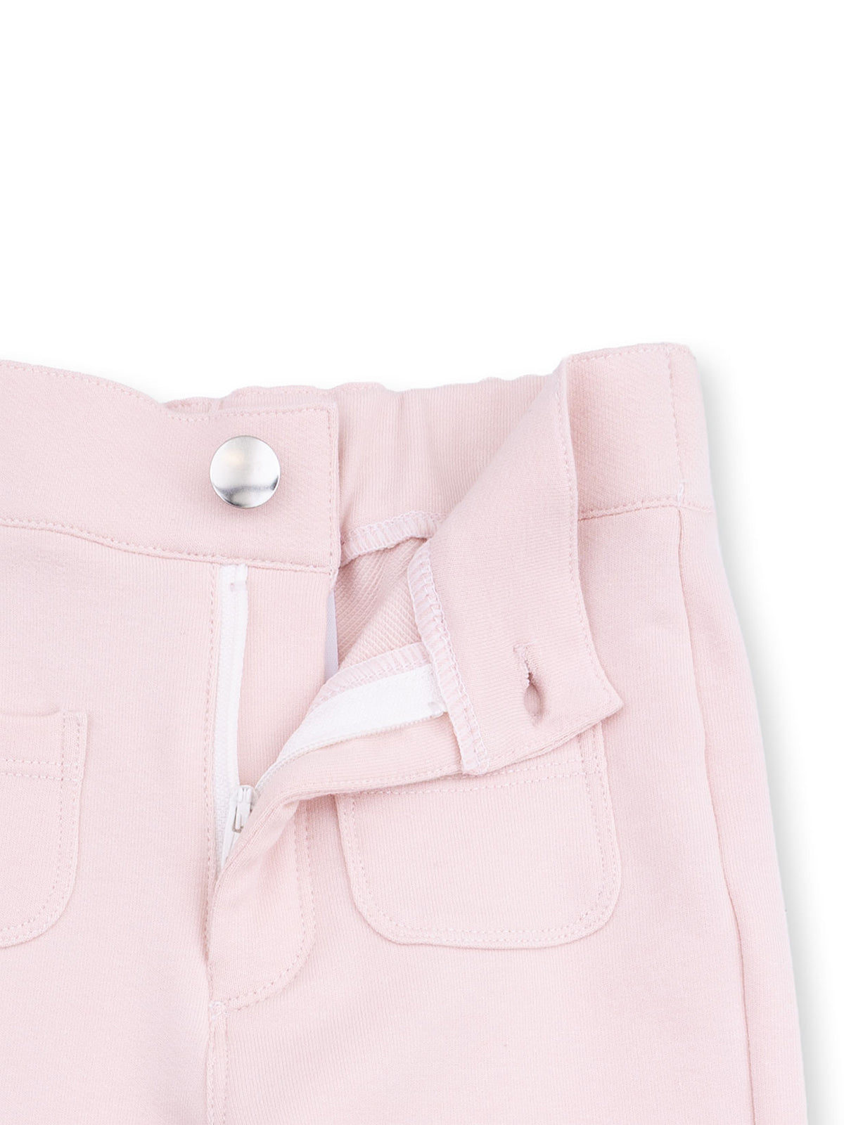 Light pink pants with a zippered front and two small pockets, featuring a silver button closure.
