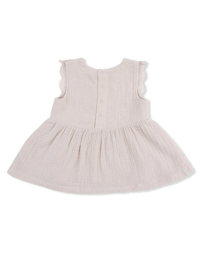 Light beige dress with ruffled sleeves and a flared skirt, featuring a button closure at the back.