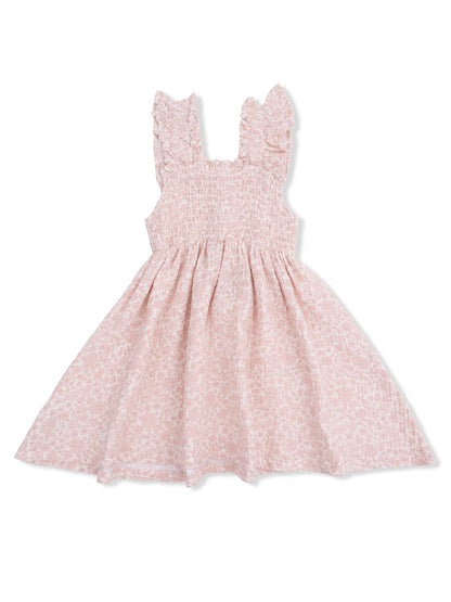 Pink floral dress with smocked bodice and ruffled straps, perfect for warm weather.