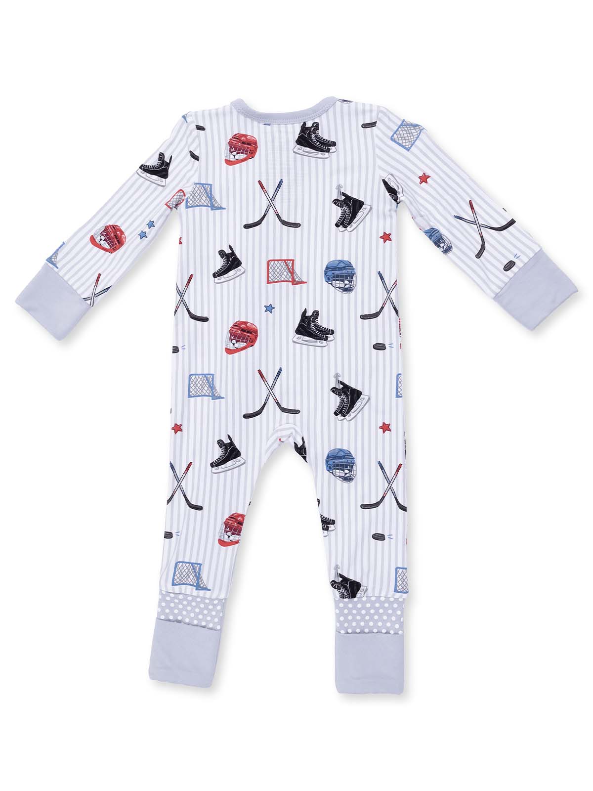 Baby pajama set in light colors featuring hockey gear illustrations, including skates, helmets, and sticks.