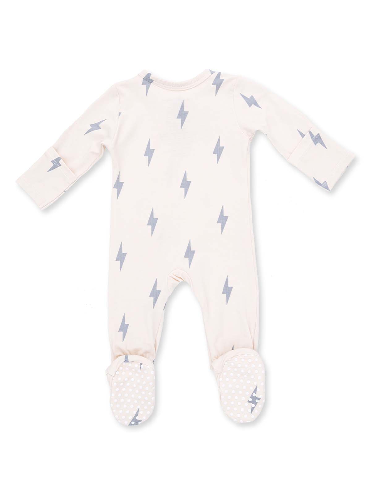 Cream-colored baby onesie with gray lightning bolt patterns and dotted footed bottoms.