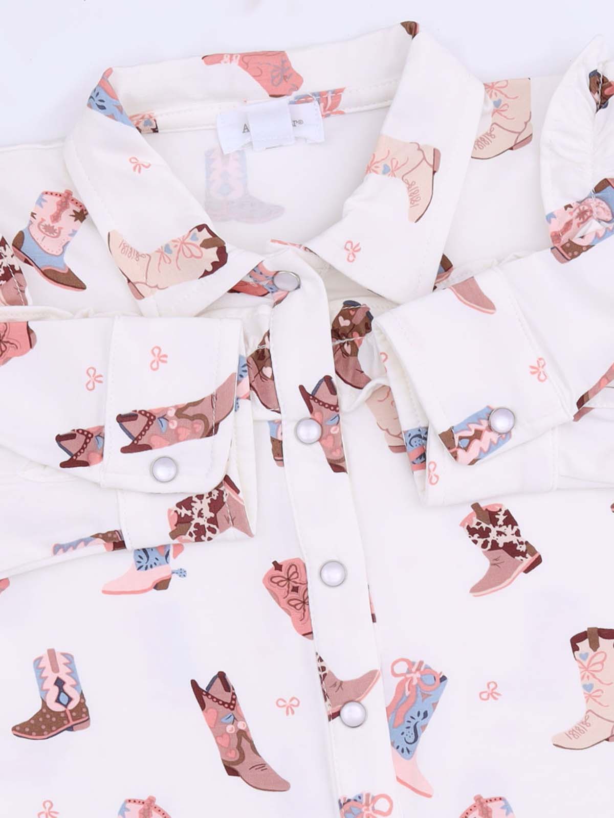 White shirt collar featuring a playful pattern of colorful cowboy boots and floral designs.