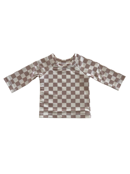 Brown and cream checkered long-sleeve children's swim shirt on a white background.