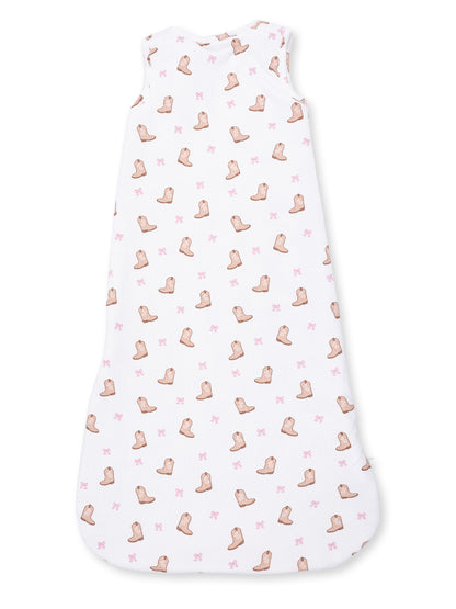 White sleeveless sleep sack with pink cowboy boot and bow patterns. Ideal for cozy sleepwear.