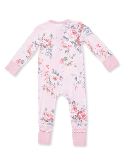 Pink floral baby onesie with long sleeves and polka dot cuffs, shown from the back. Perfect for comfortable, stylish wear.