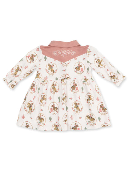 White dress with cowboy pattern and pink collar, featuring a western-themed design and floral accents.