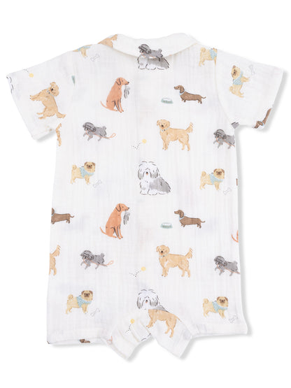 White onesie with colorful dog illustrations scattered throughout the fabric.