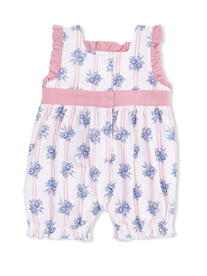 Floral baby romper in pink and blue with ruffled straps and a button closure. Perfect for spring/summer wear.