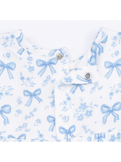 Blue floral pattern fabric with bows, featuring snaps at the neckline. Ideal for children's clothing.
