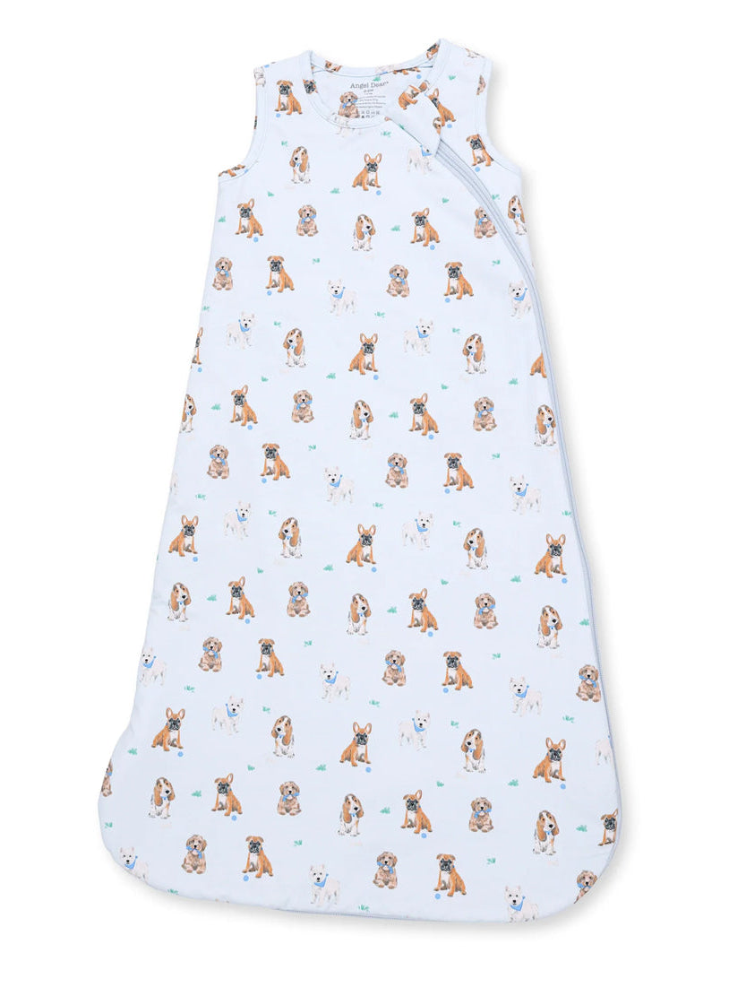 Light blue sleep sack featuring playful puppy illustrations in various poses on a soft fabric background.