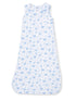 Sleeveless baby sleep sack with blue bow and floral pattern on a white background. Ideal for comfort and safety.