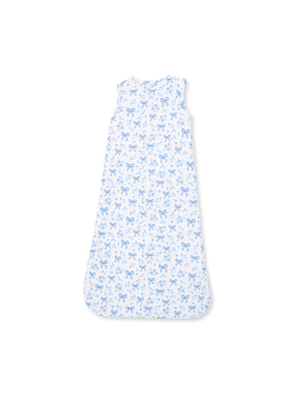 Children's sleep sack in white with a blue bow and floral pattern, designed for comfort and safety.