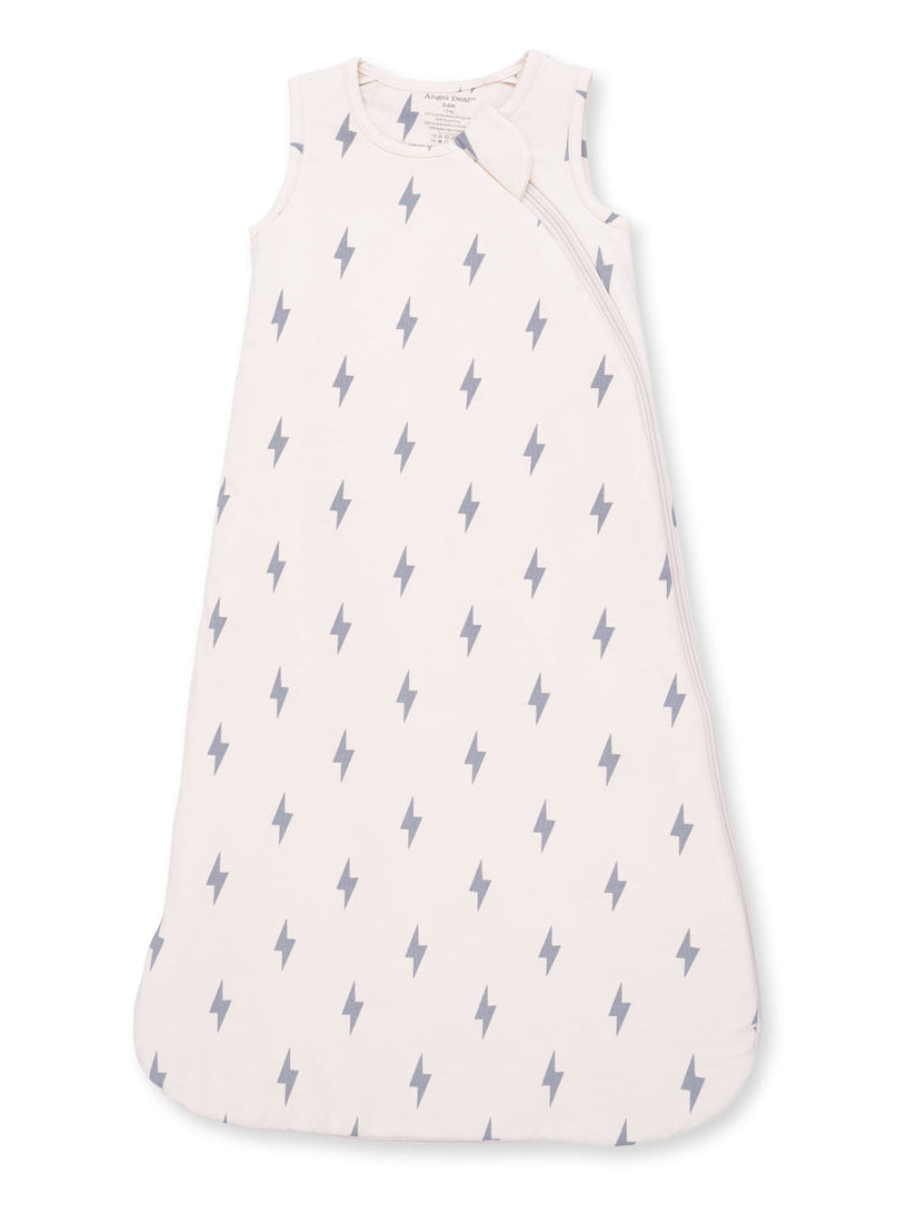 Light pink baby sleep sack with gray lightning bolt pattern, featuring a zip closure and sleeveless design.