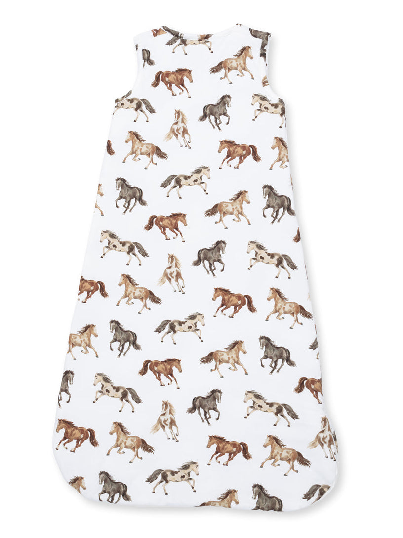 Child's sleep sack featuring a playful horse print in various colors on a white background.