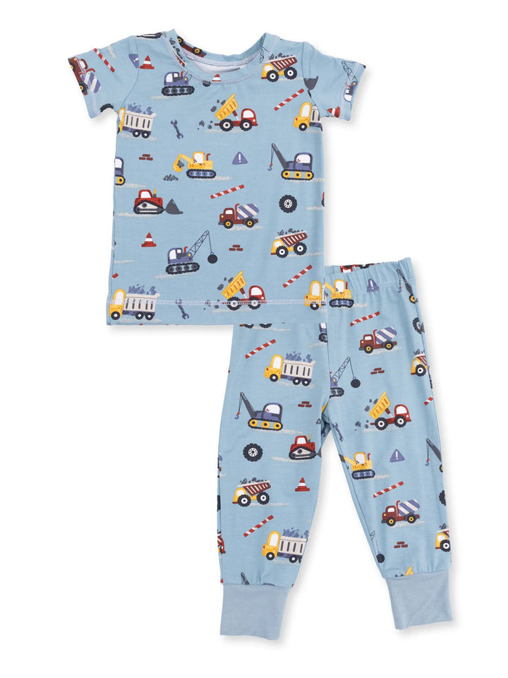 Blue children's pajamas featuring construction vehicle patterns, including trucks, cranes, and traffic cones.