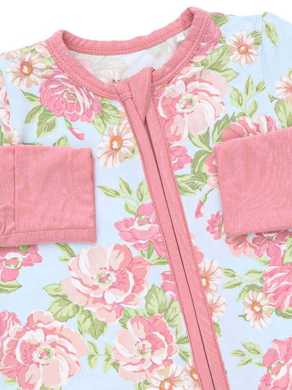 Floral-patterned children's romper in soft pastel colors with a pink zipper and sleeves.