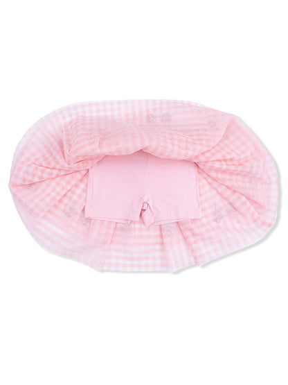 Pink gingham fabric draped over pink shorts, creating a soft, playful outfit layout.