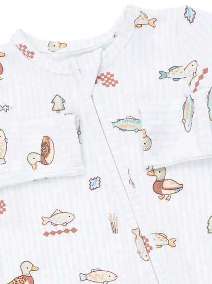 White outfit featuring playful duck and fish patterns with a zip front and small pocket detail.