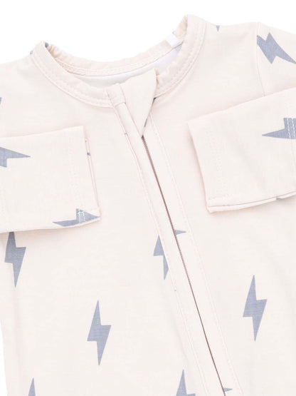 Light-colored baby outfit with gray lightning bolt patterns and a zip front. Designed for comfort and style.