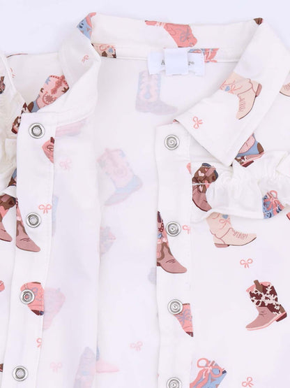 White shirt with colorful cowboy boot prints and button closures. Ideal for casual wear.
