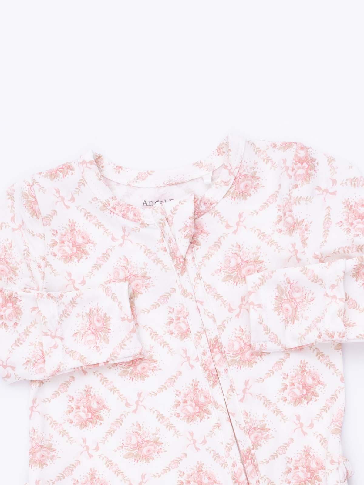 Floral-patterned children's pajama top in soft pink and white, featuring button closure and long sleeves.