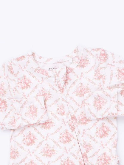 Floral-patterned children's pajama top in soft pink and white, featuring button closure and long sleeves.