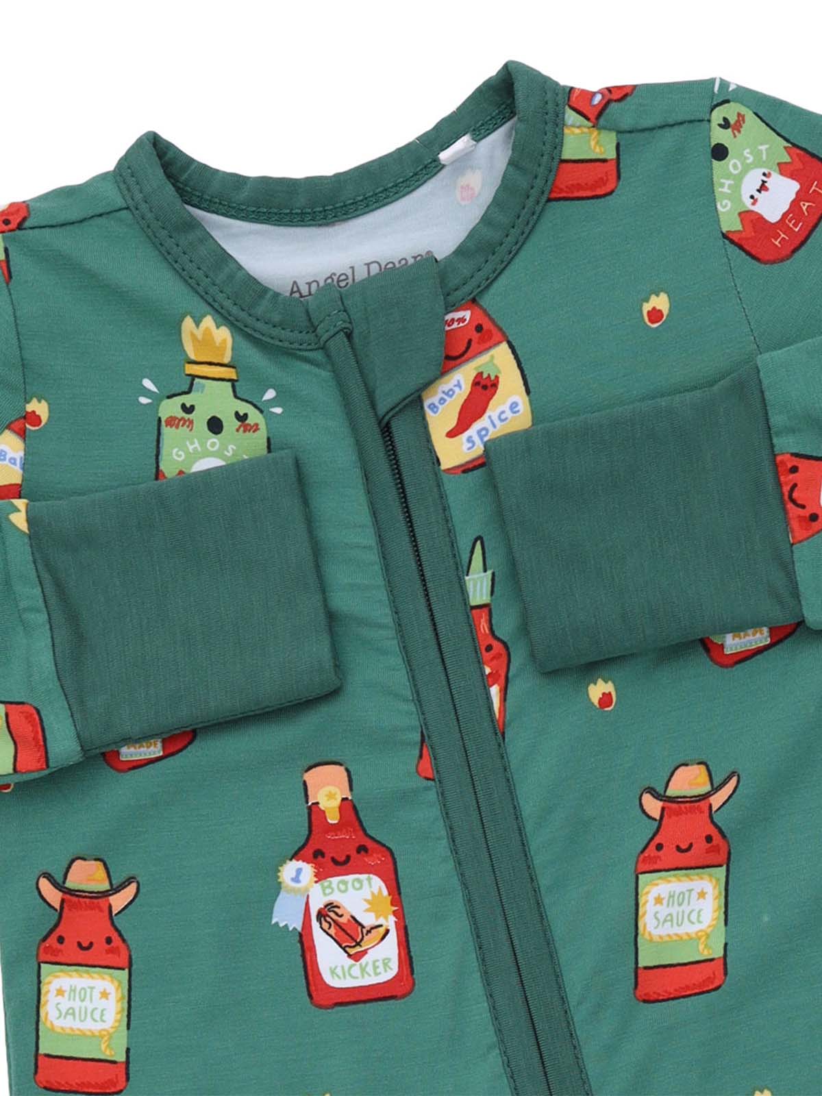 Green onesie featuring playful hot sauce bottle illustrations in various colors and designs.