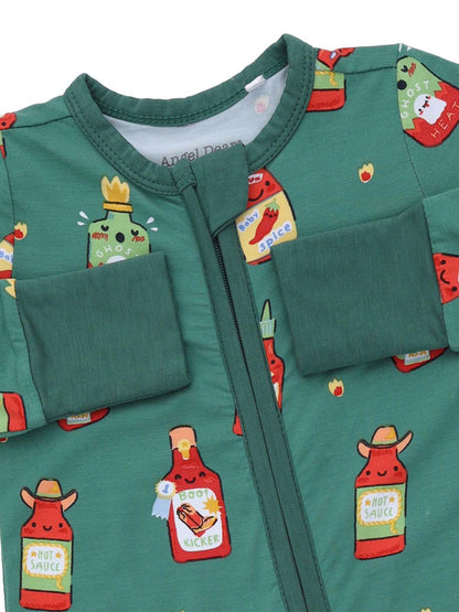 Green onesie featuring playful hot sauce bottle illustrations in various colors and designs.
