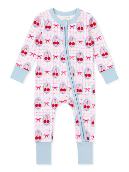 Baby jumpsuit with cherry pattern on pink gingham background and blue accents. Features full front zipper.