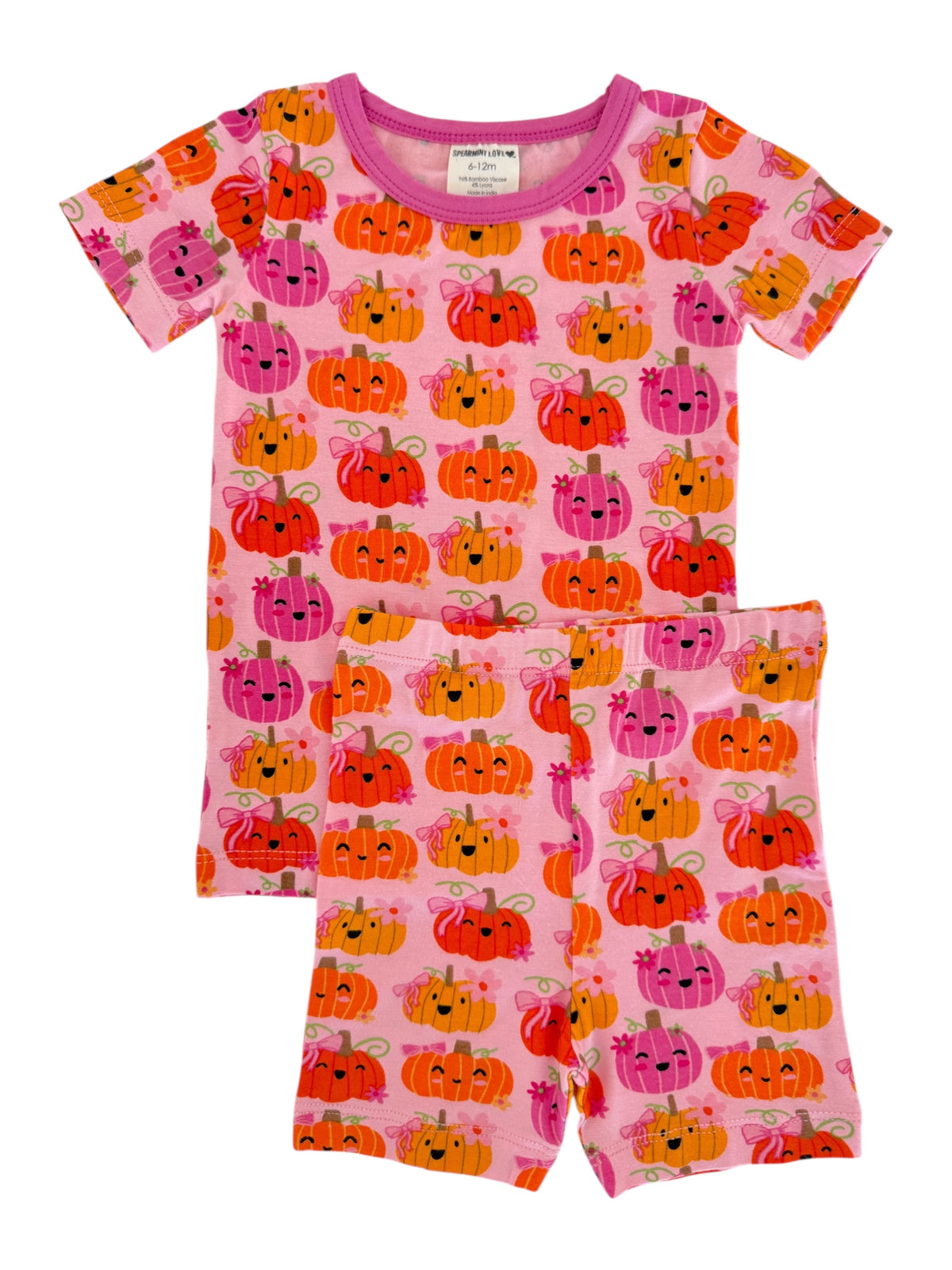 Pink pajama set featuring colorful, smiling pumpkins with bows, suitable for infants and toddlers.