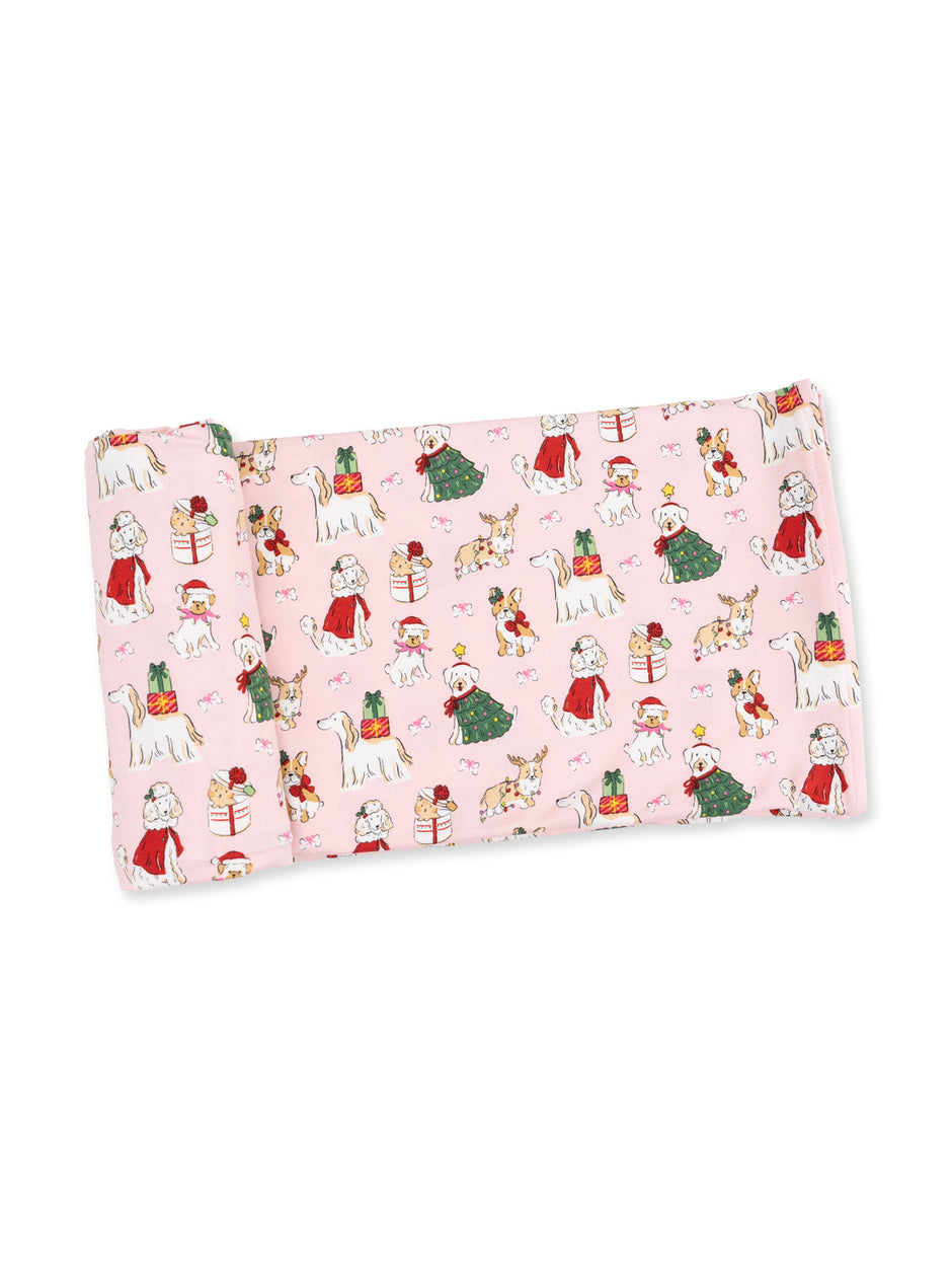 Pink fabric featuring holiday-themed dogs and cats with gifts and festive attire.